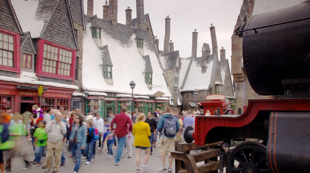 Exploring a bustling street in Universal Studios Florida with snowy rooftops and lively crowds