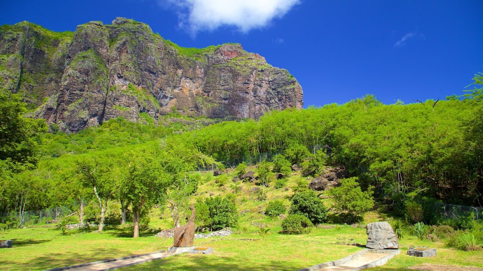 A mountainous landscape with lush green vegetation and a clear blue sky.