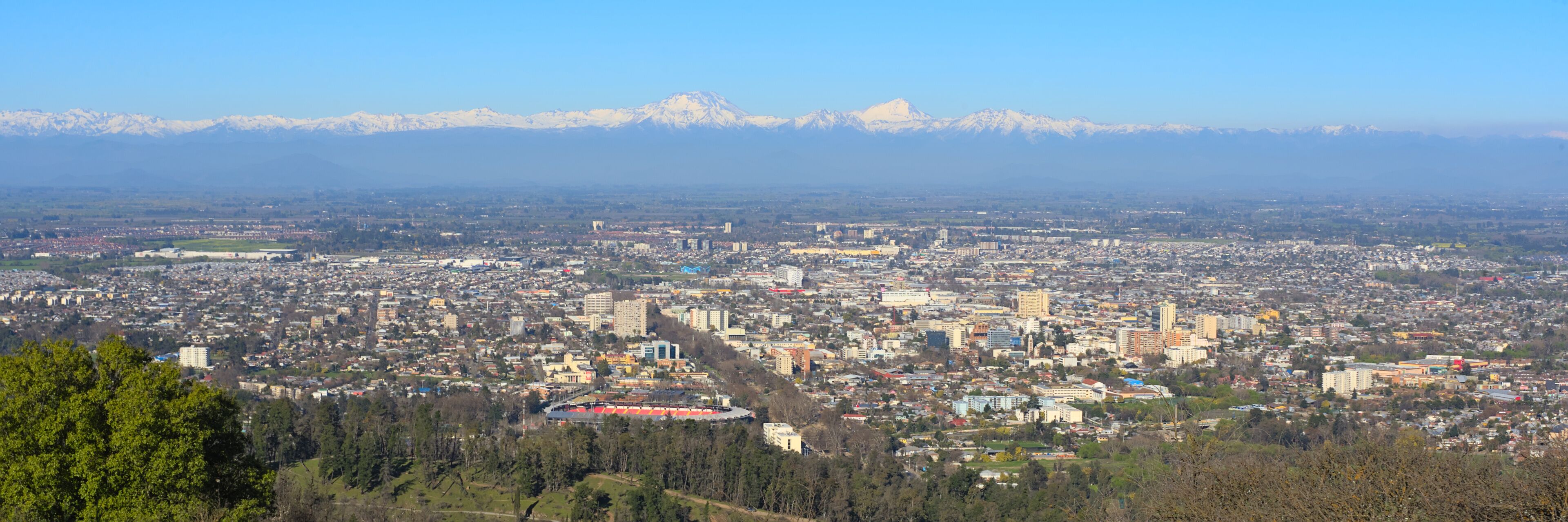 A cityscape with a mountain range in the background.