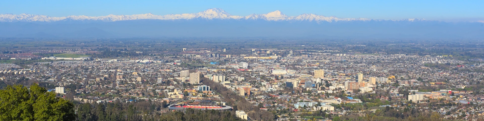 A cityscape with a mountain range in the background.