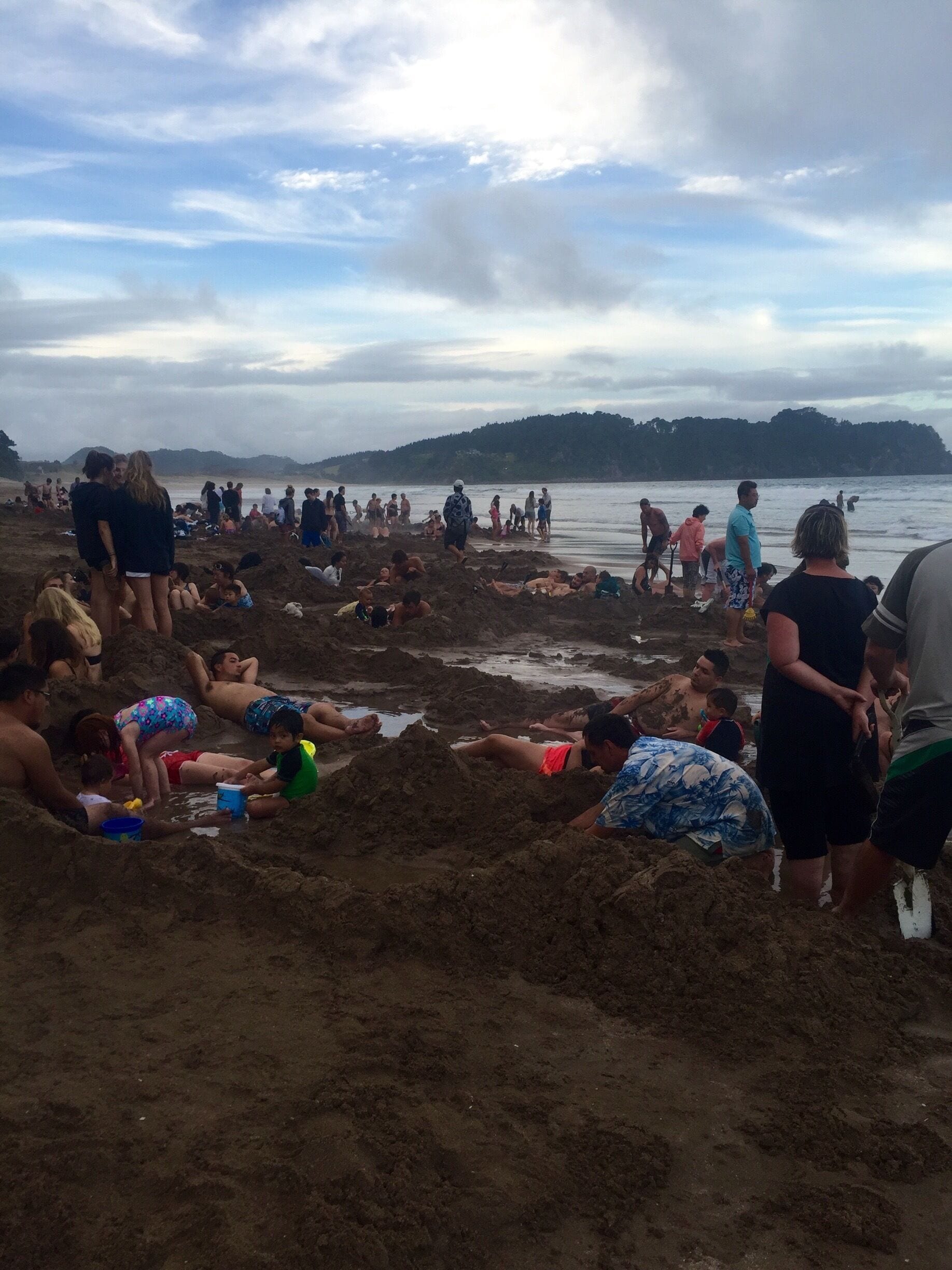 Hot water beach is quite the experience. You have to go 2hours +/- low tide, bring a spade (most places rent them, I was able to get one from my hostel), and you can dig your own hot tub on the beach! However it definitely takes more than one person to dig the right size hole! So make some friends and work together! It's also not a very big area, and only some spots are hot, so you can start digging and have a "bust" of a location. It's very strange and super awesome. And warning it's VERY HOT in places. I near burned myself numerous times with my hands or feet digging deeper in the sand! 
Overall though - DO IT. Awesome, can't do most places experience. 