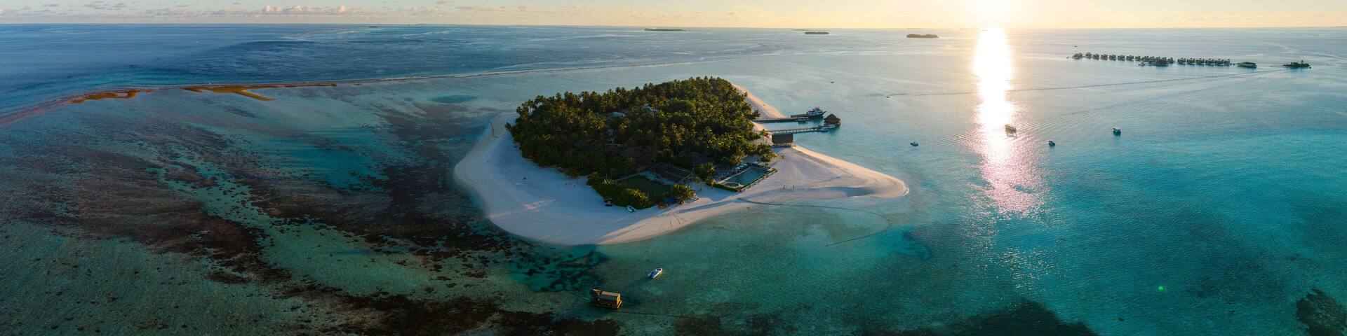 Aerial views of Velavaru Island at sunset in Maldives