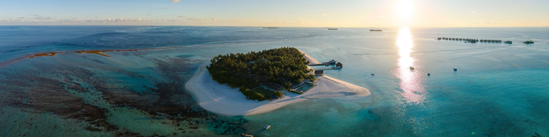 Aerial views of Velavaru Island at sunset in Maldives
