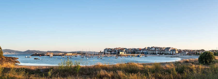 Panorama view of the beach and sport port of Portonovo in the Ria de Pontevedra at dusk, Spain.