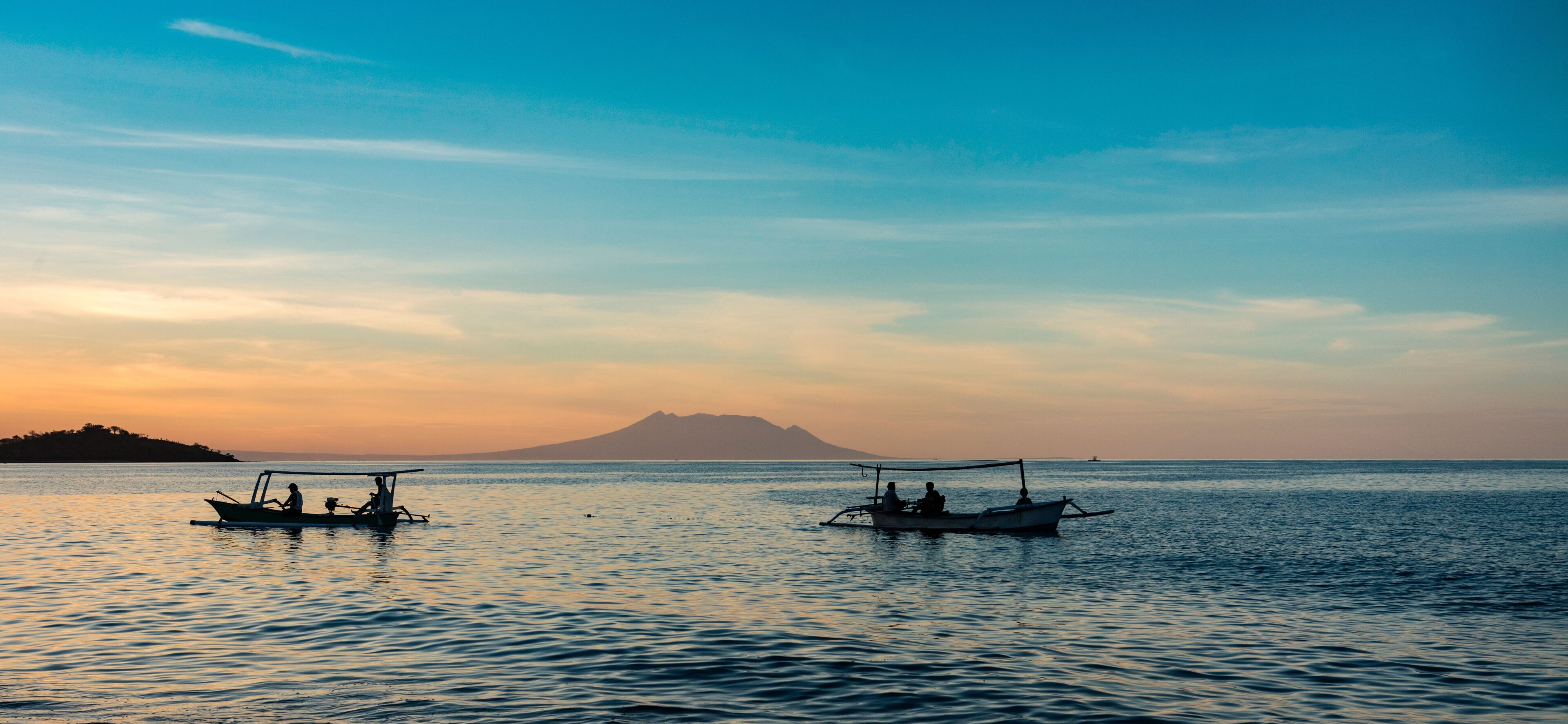 Local fishermen in their boat in Bali at sunset