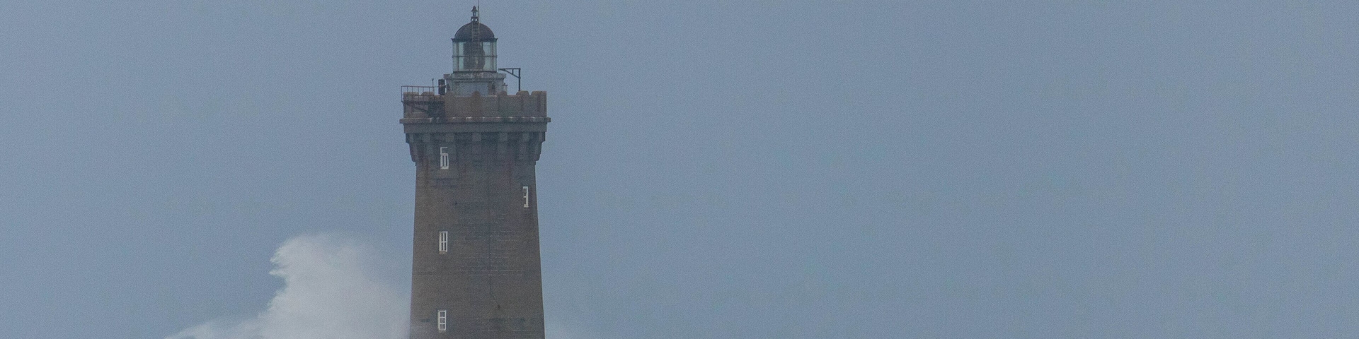 Strong winds made the waves crash beautifully on the lighthouse.