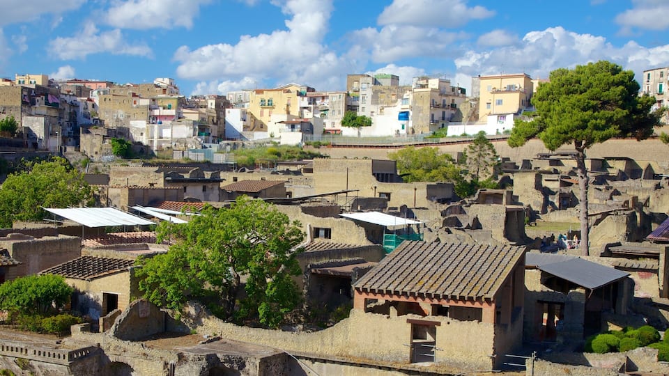 An ancient city with ruins and modern buildings under a clear sky.