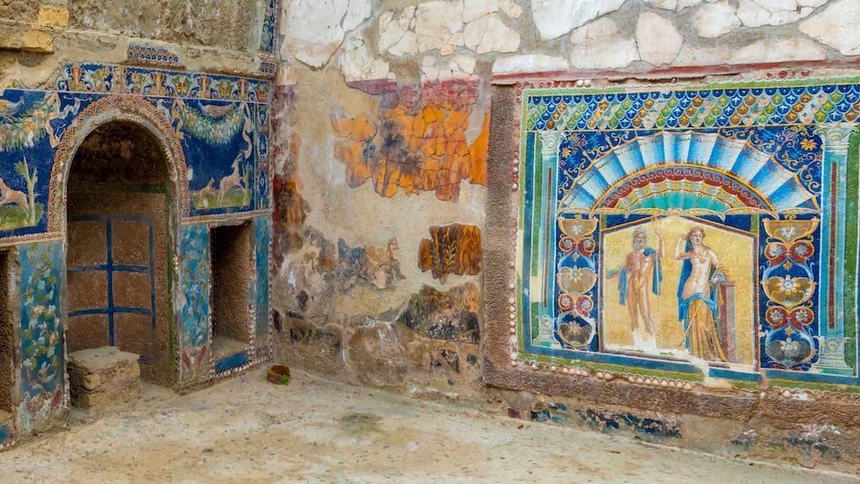 A historical building with intricate mosaic artwork and stone arches.