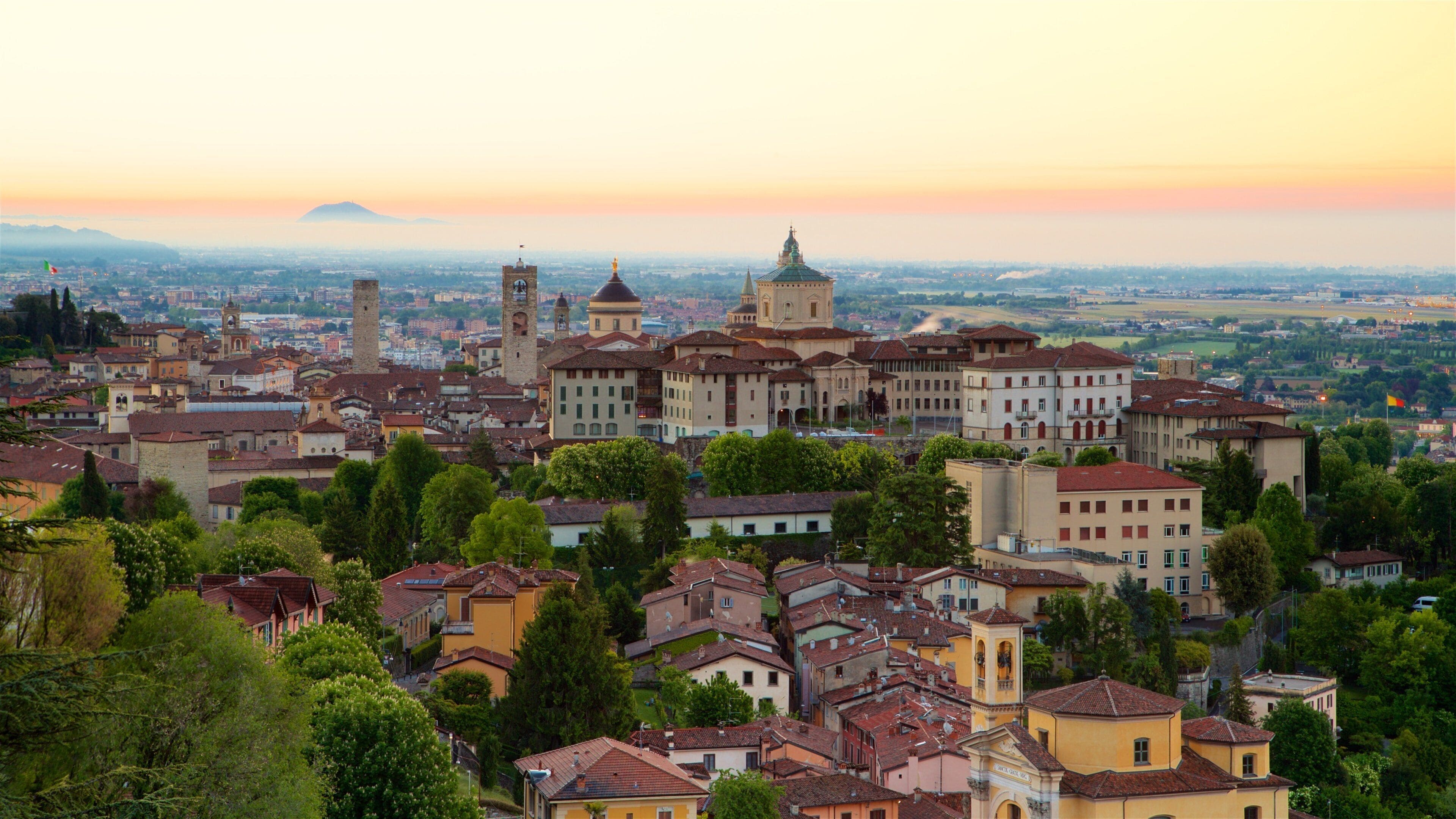 Bergamo showing landscape views, a sunset and a city