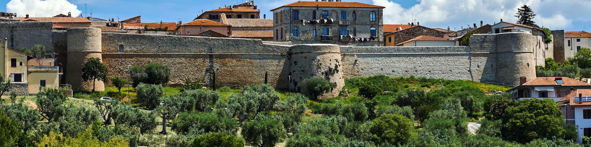Medieval fortified walls and towers in city of Magliano in Tuscany, Italy..