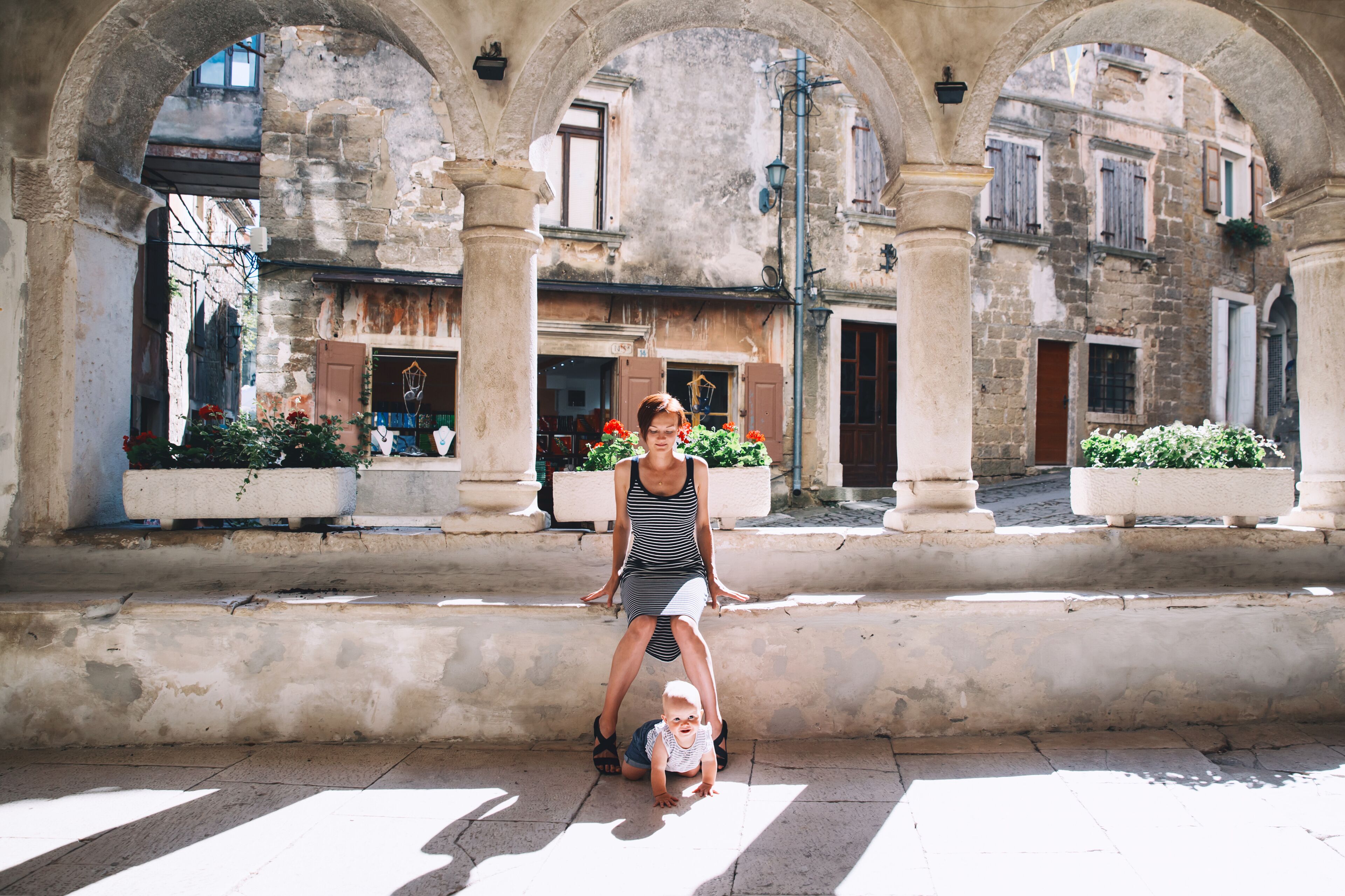 Mother with baby in historical old town of Groznjan, Croatia