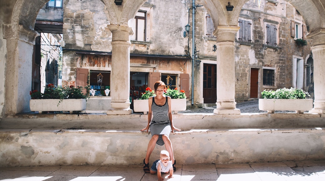 Mother with baby in historical old town of Groznjan, Croatia