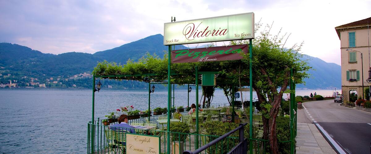A lakeside restaurant named Victoria with outdoor seating and a view of the lake and mountains.