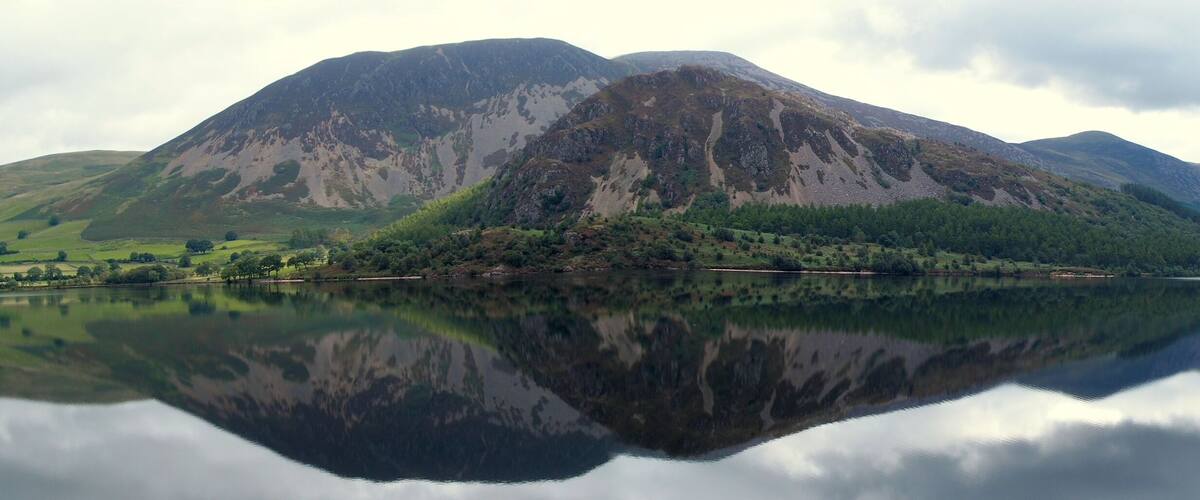 A mountain lake with reflections of the surrounding landscape.