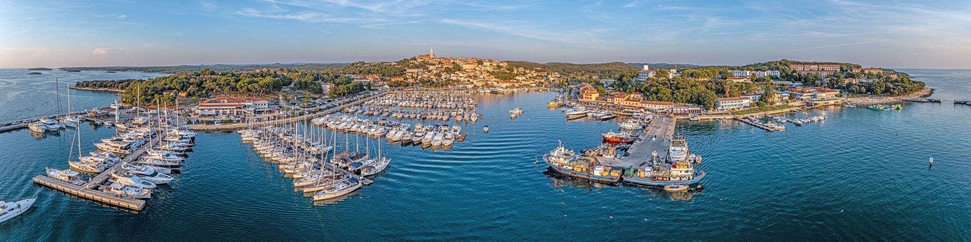 Drone panorama over the harbor of Croatian coastal town Vrsar in Istria during sunset