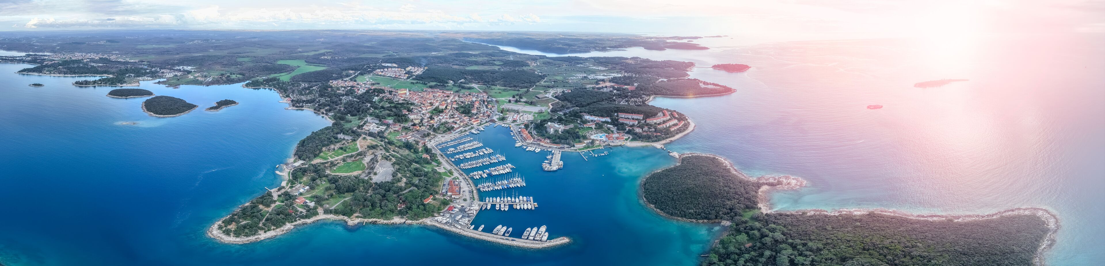 Aerial panoramic view of Adriatic Sea coastline with group of islands near Funtana town a at sunset time, Istria peninsula, Croatia