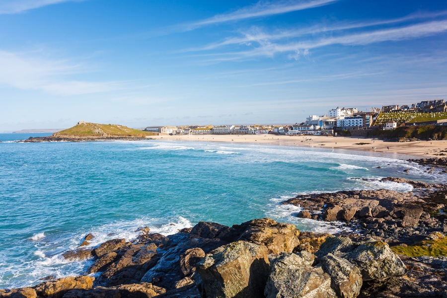 Overlooking the golden sandy Porthmeor Beach St Ives Cornwall England with The Island headland in the distance.; Shutterstock ID 265617323