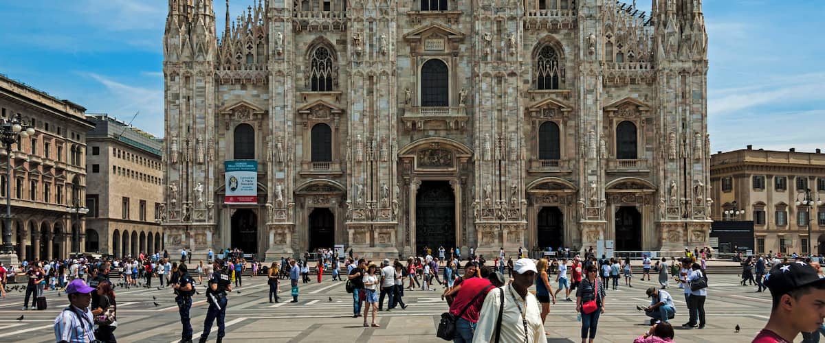 The Duomo of Milan seen from the Piazza, with tourists around on a typical summer day