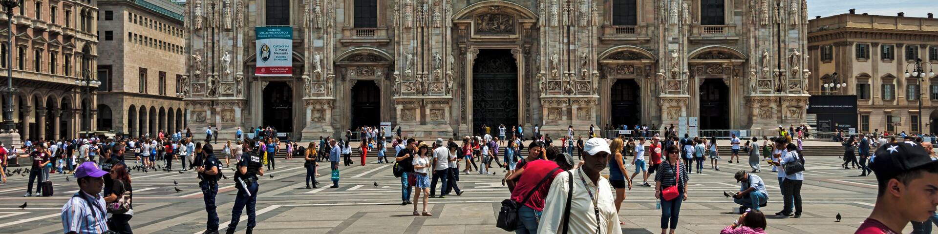 The Duomo of Milan seen from the Piazza, with tourists around on a typical summer day