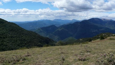 A mountainous landscape with rolling hills and a clear sky.