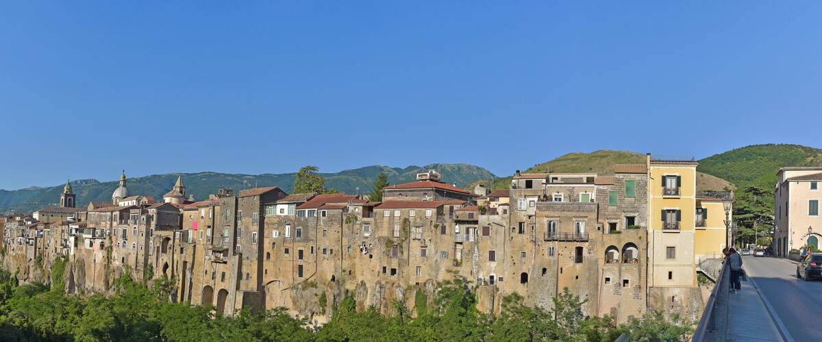 A historic town with ancient stone buildings and a clear blue sky.