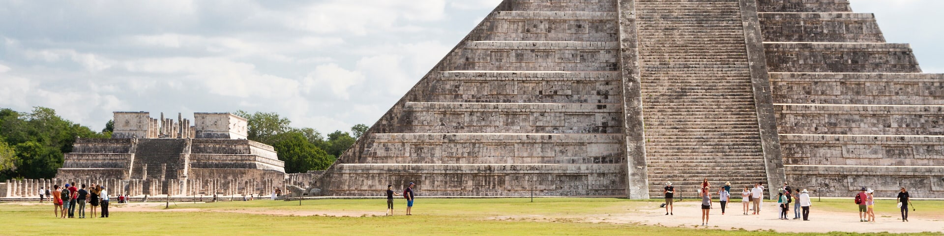 A large pyramid with tourists in the foreground.