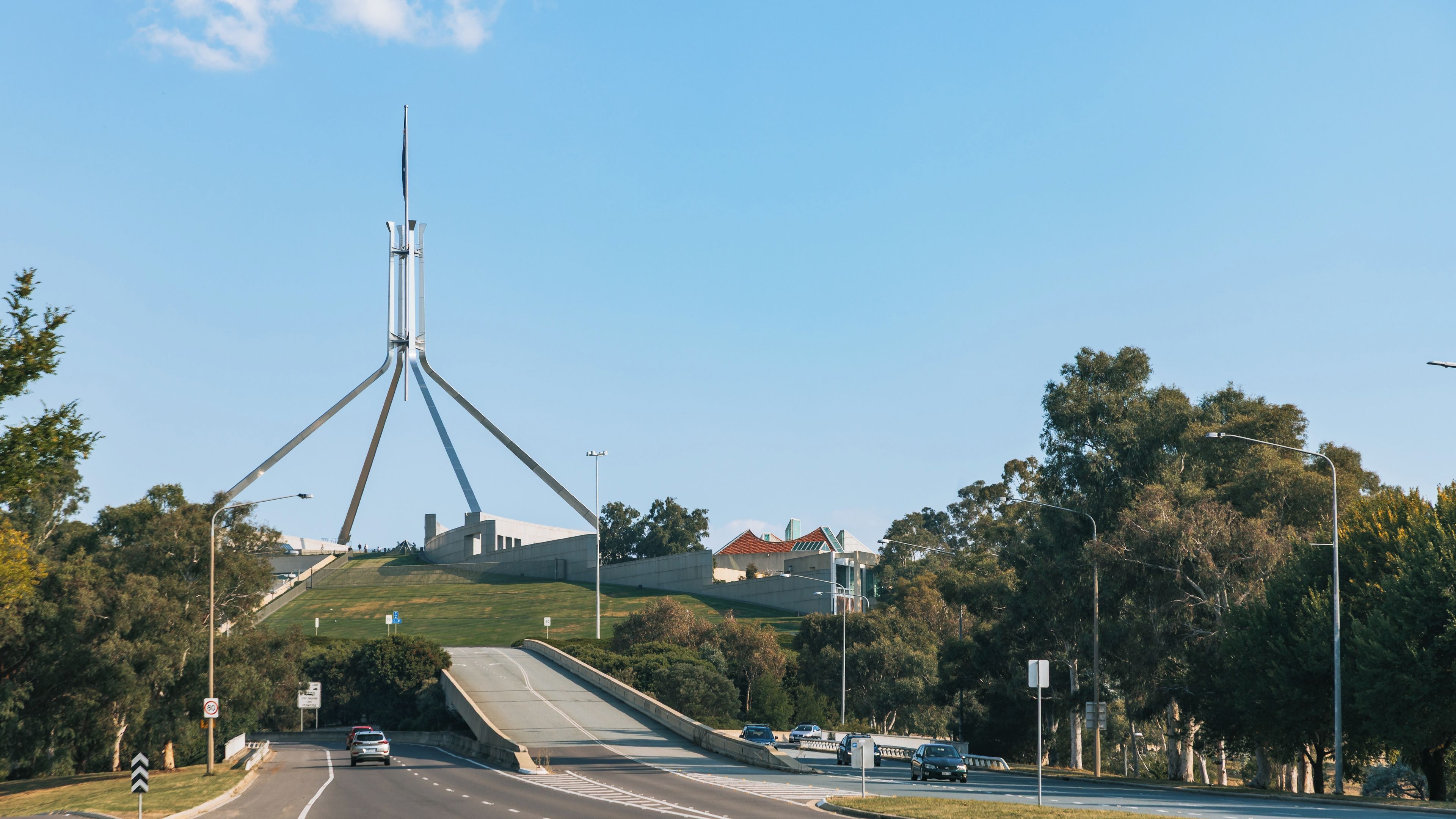 A road with vehicles, a bridge, and a tower-like structure.