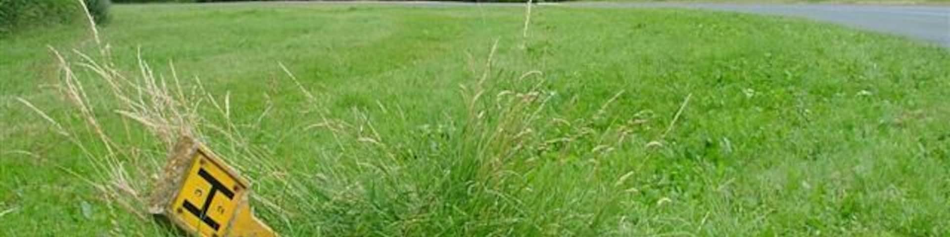 Water Hydrant Sign at Maynards Corner. This sharp bend on the B1257 takes its name from the nurseries seen beyond the road.