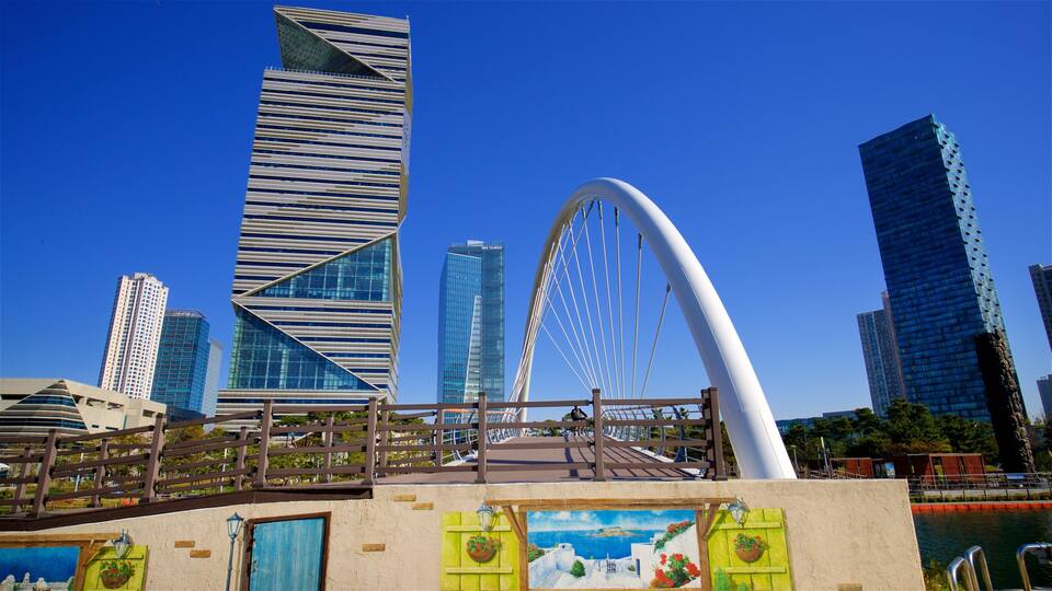 A modern cityscape with a distinctive bridge and tall buildings.