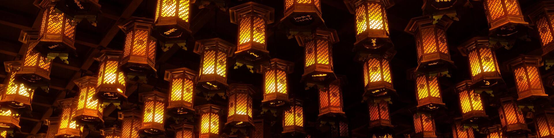 Thousands of lanterns hanging on the ceiling of Buddhist temple Shrine.