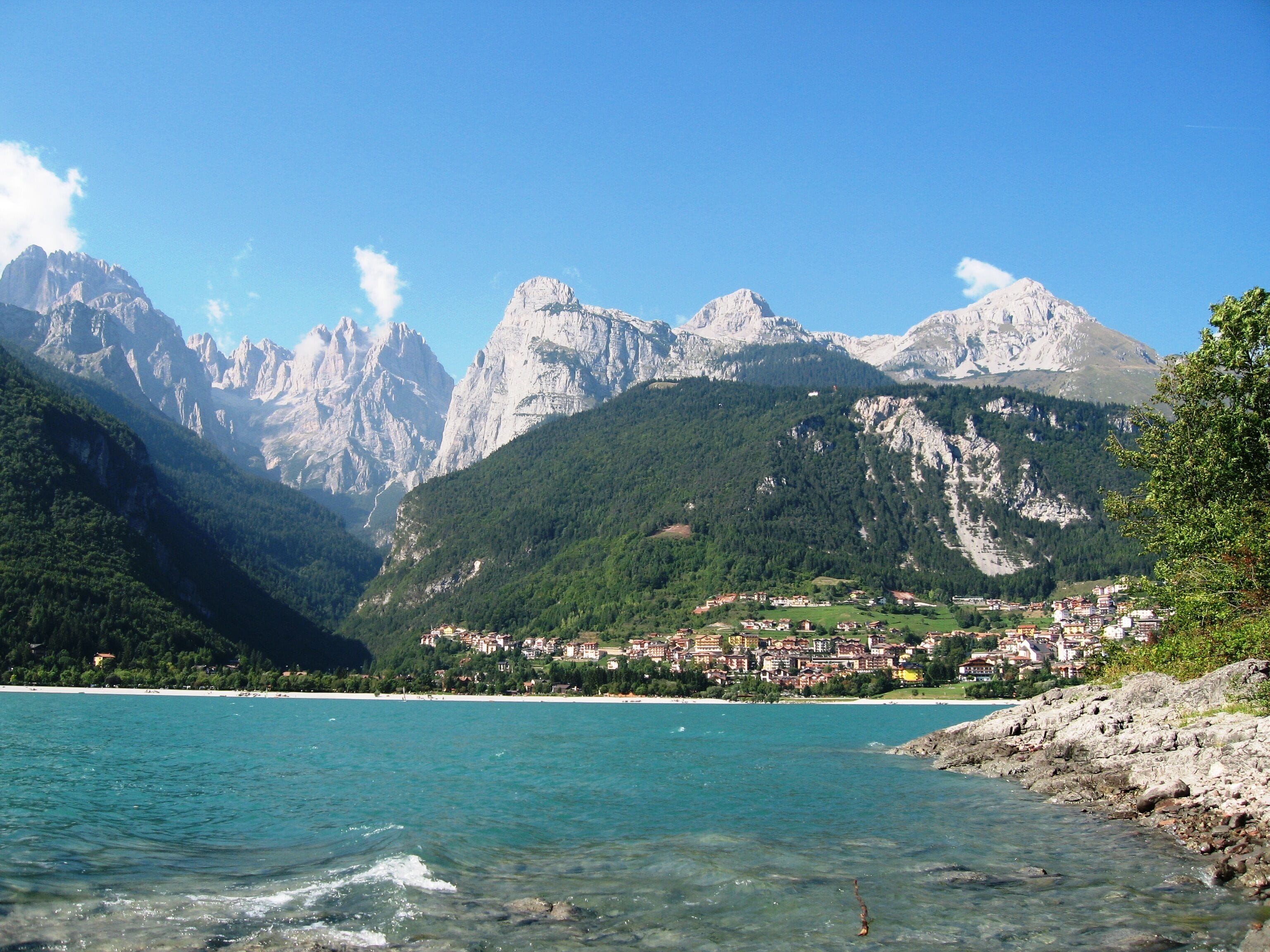 A mountainous landscape with a lake and a town.
