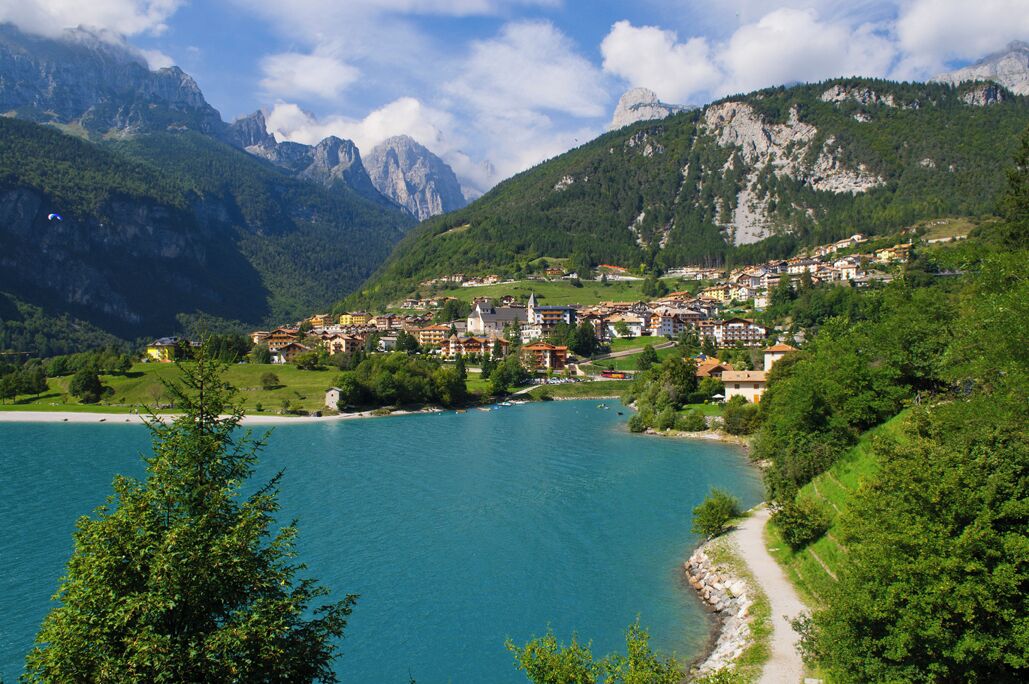A lakeside town with mountains in the background.