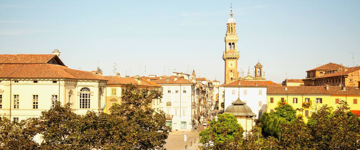 A historic town with a prominent tower and traditional buildings.