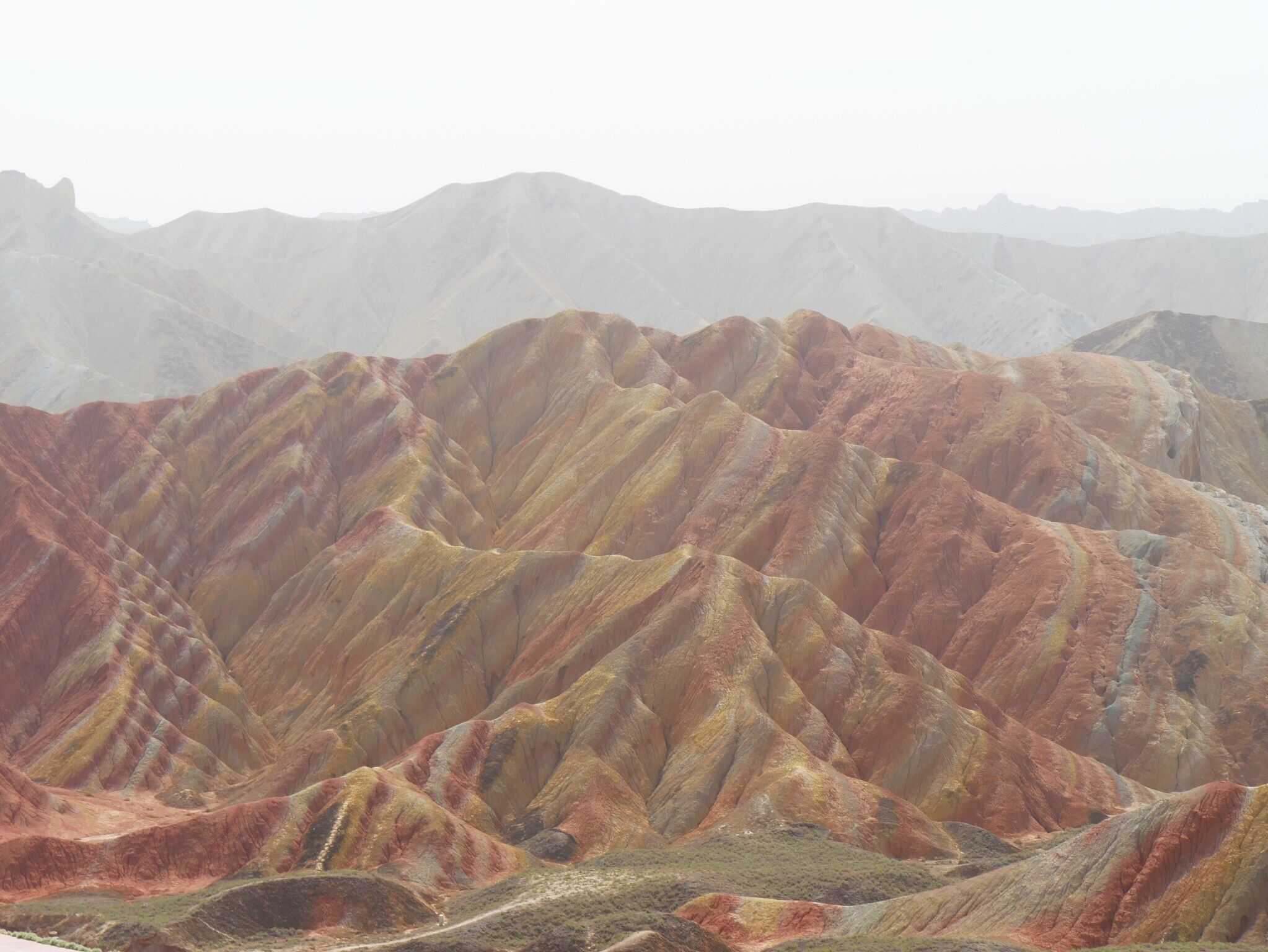 Zhangye National Geopark, the "Rainbow" or "Colorful" Mountains. About 30 minutes west of the city of Zhangye in the Gansu province of China. Buses from two park tourist centers ferry you to 4-6 stops within the park where you can climb up to various viewing platforms and walkways.
#Red