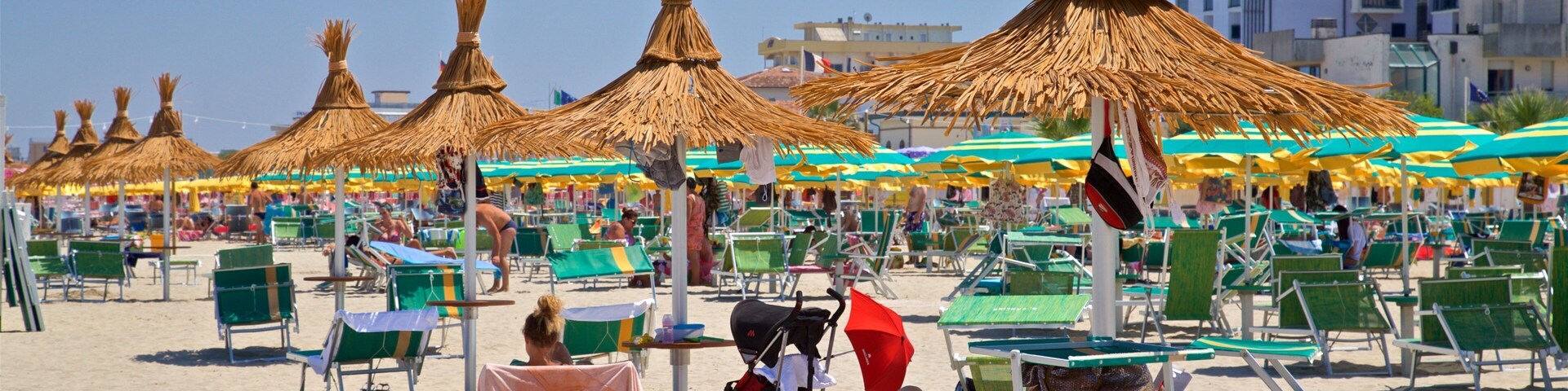 Torre Pedrera featuring a sandy beach and general coastal views as well as a small group of people