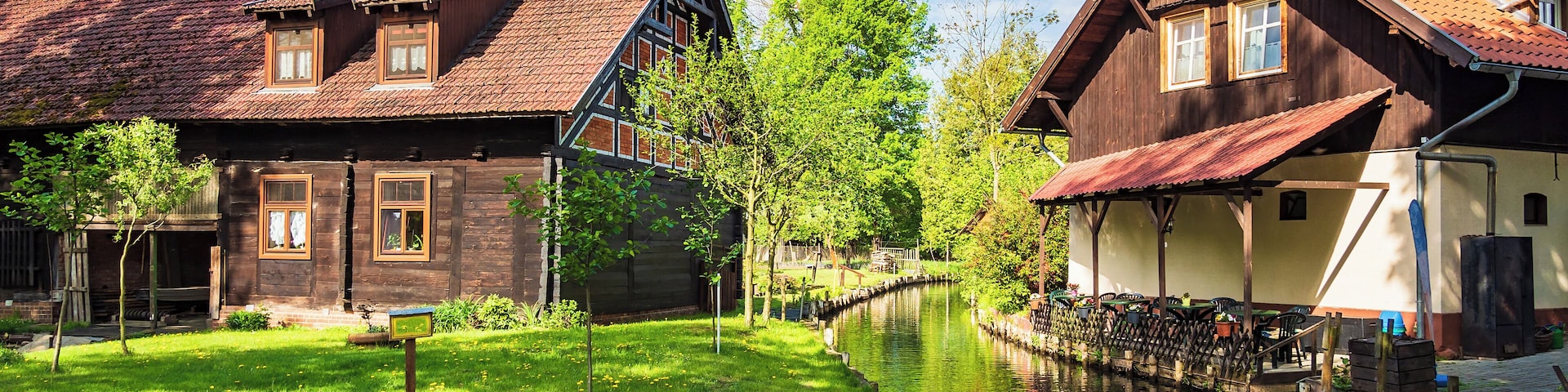 A canal with traditional wooden houses on either side.