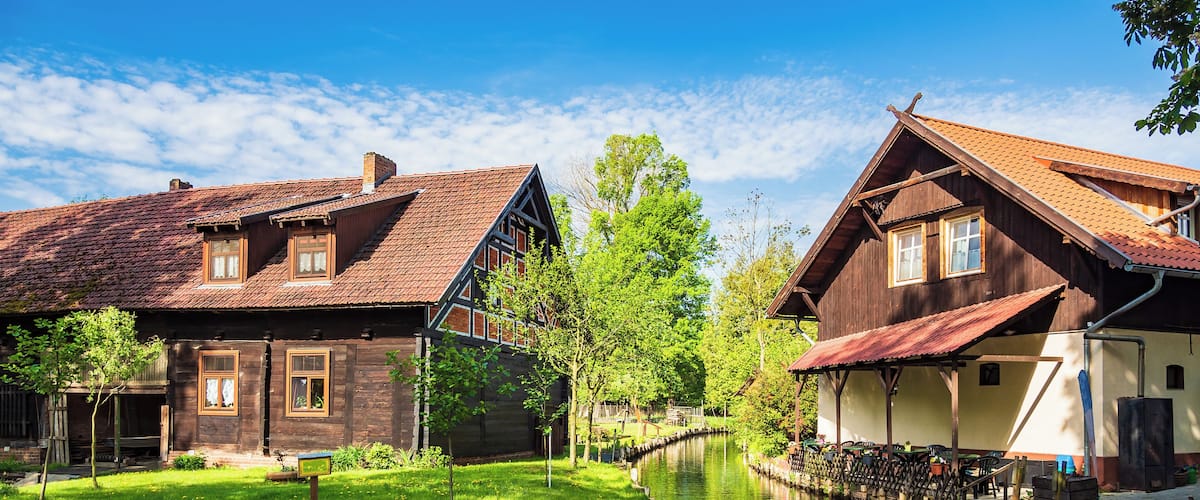 A canal with traditional wooden houses on either side.