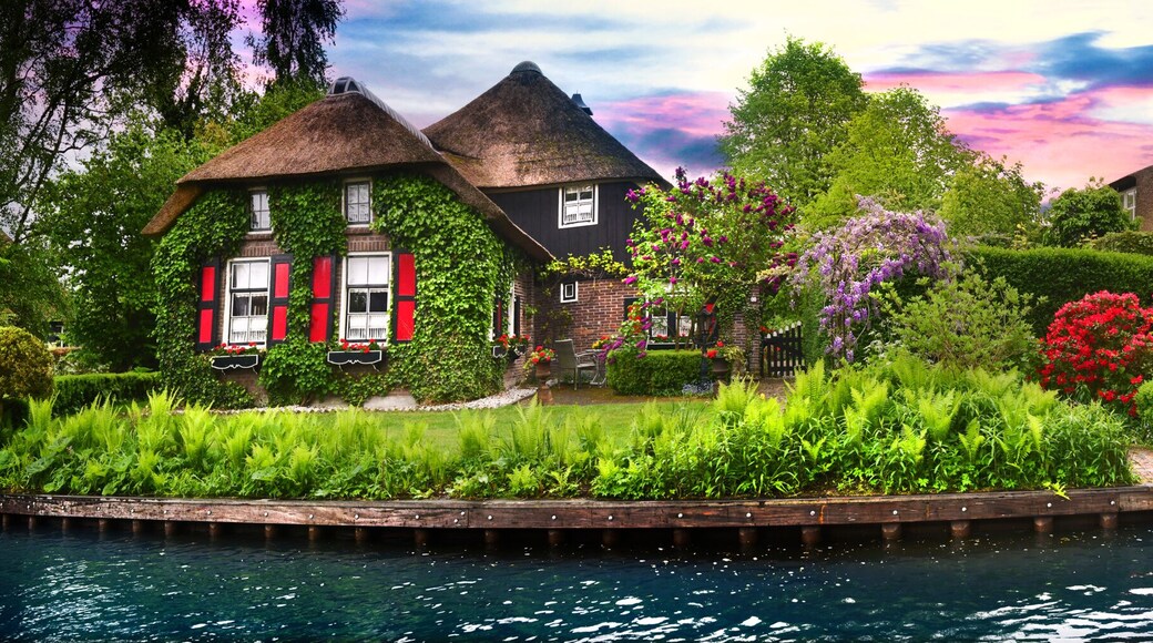 Landscape of Giethoorn village with water canals and rustic houses in netherland wide banner or panorama.