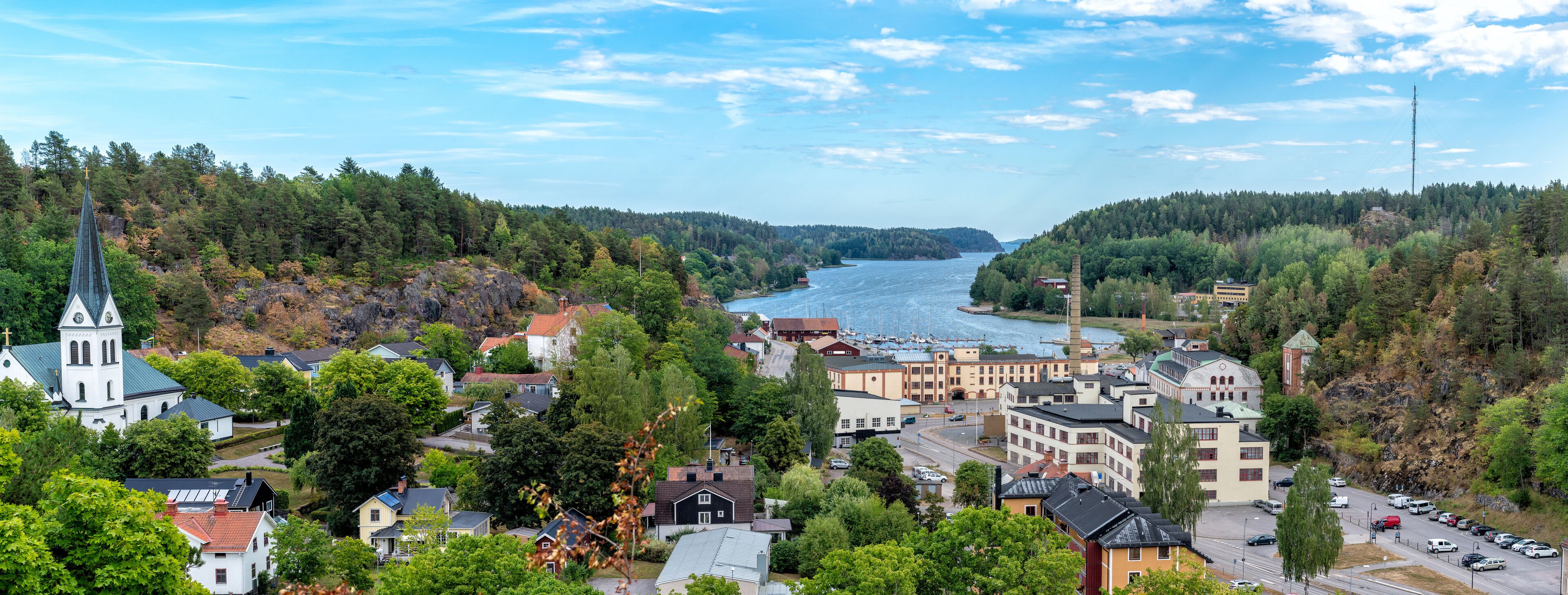 A coastal town with a church, residential buildings, and a river.