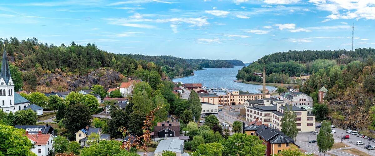 A coastal town with a church, residential buildings, and a river.