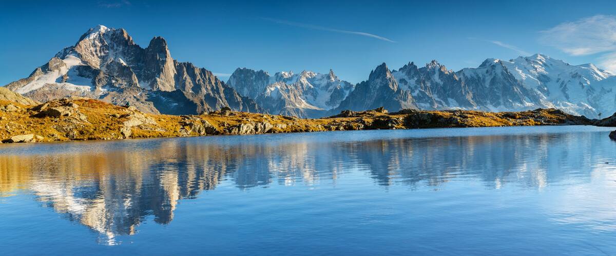 A mountain range with a calm lake reflecting the peaks.
