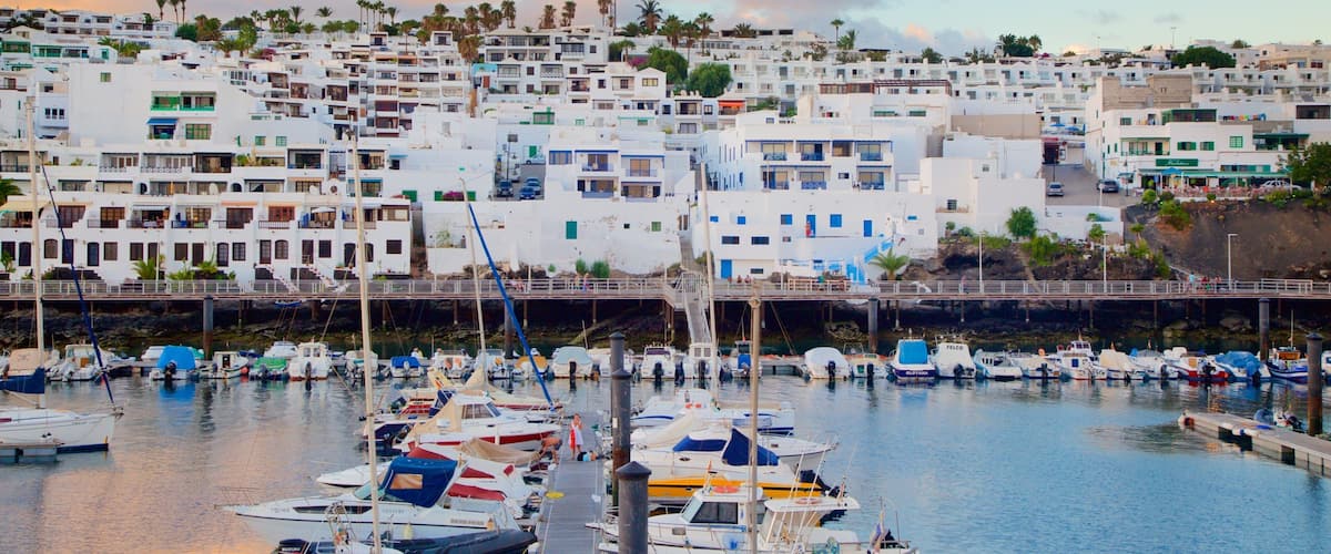 Puerto del Carmen which includes a coastal town, boating and a bay or harbour