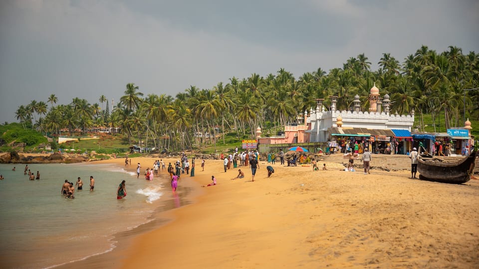 A beach with palm trees, a temple, and a boat.