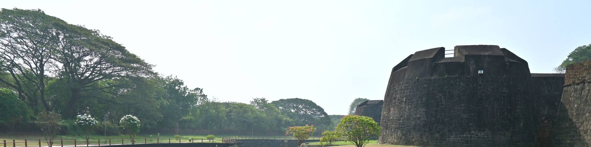 A moat surrounding a stone fortress with a river in the middle.