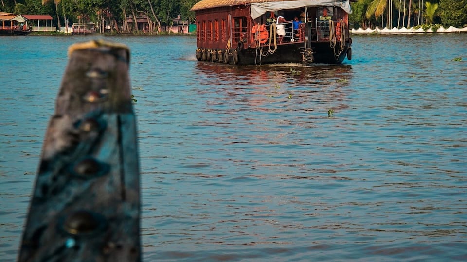 Beautiful backwaters of Alleppey , with coconut trees aligned along the banks and rich blue pristine sky. Kerala is also known as God's own Country. It's beauty is beyond words. One should spend a night in houseboat in the backwaters.