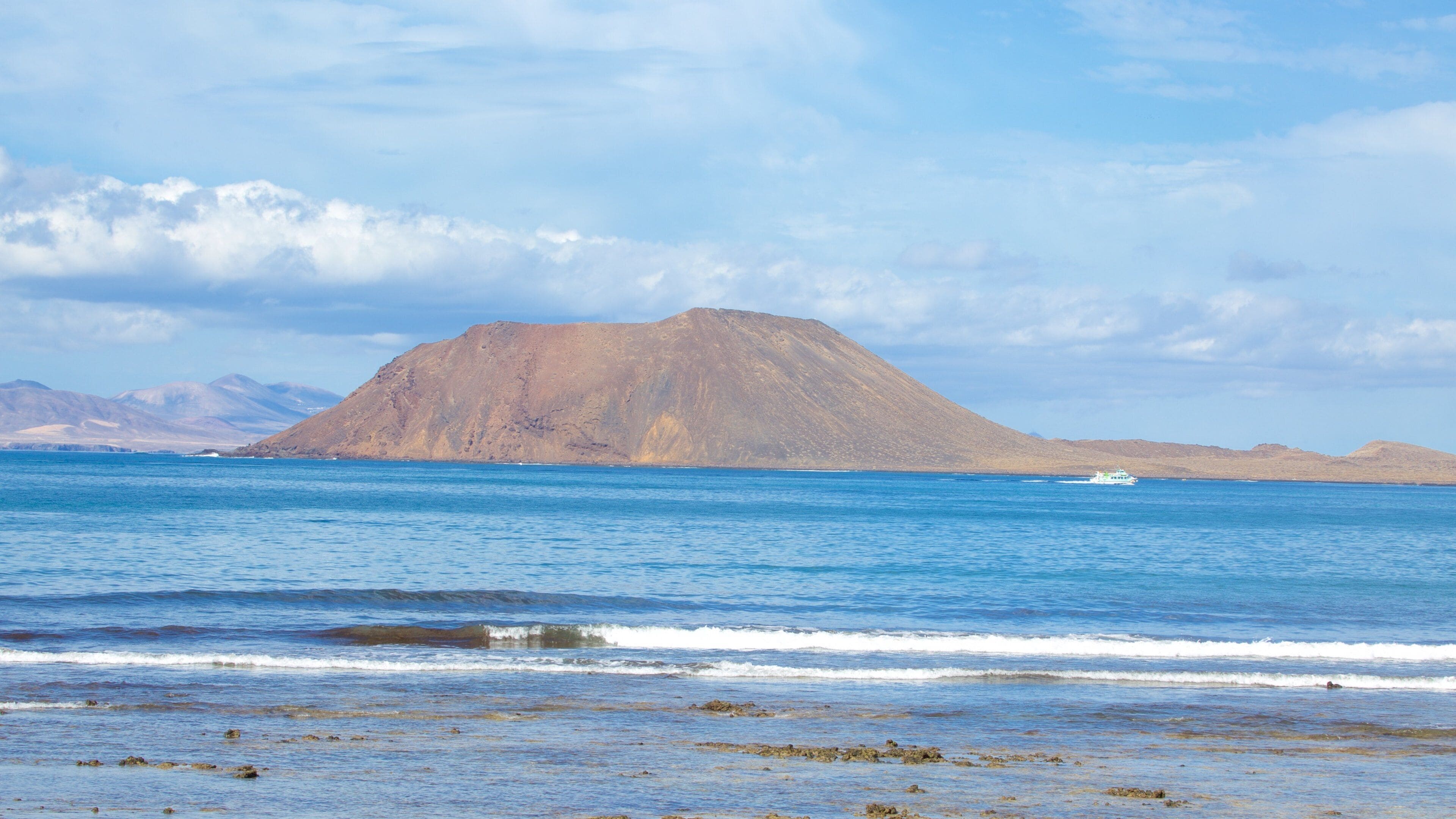 Corralejo which includes general coastal views and mountains