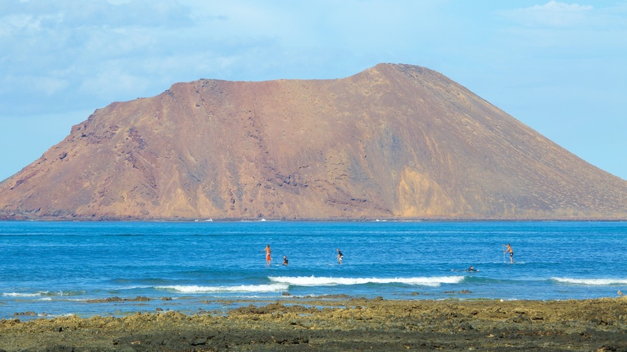 Corralejo featuring general coastal views, swimming and mountains