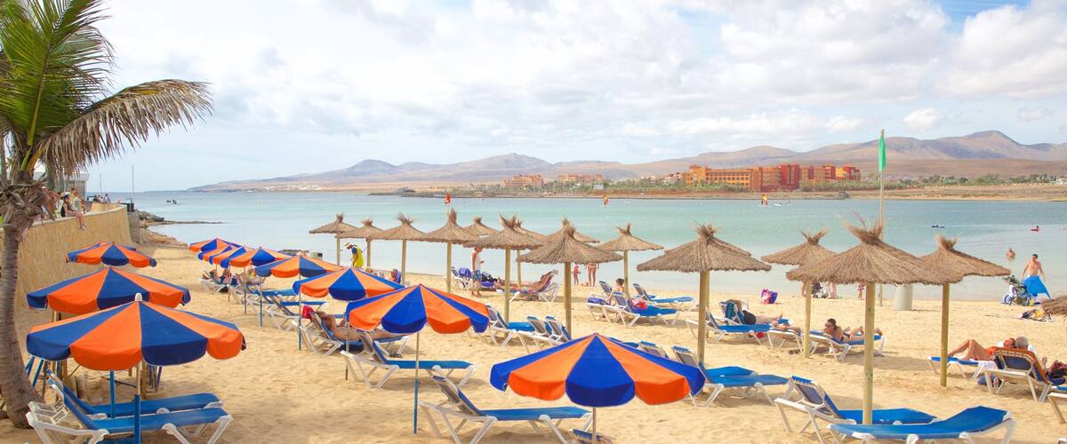 Caleta de Fuste featuring a beach, a luxury hotel or resort and general coastal views