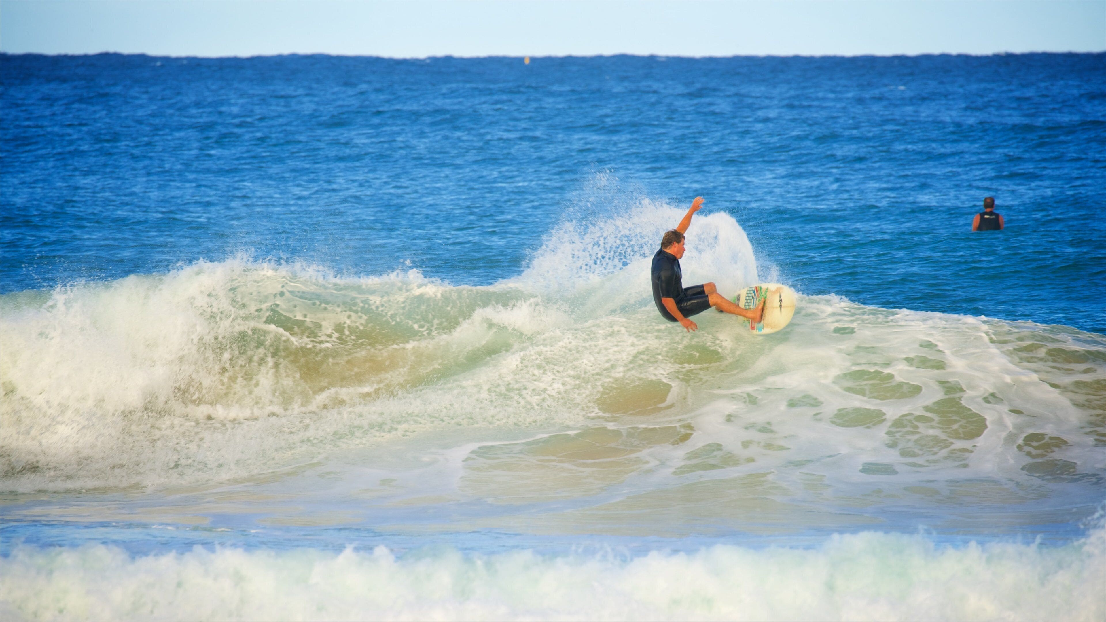 Avoca Beach showing a bay or harbor, waves and surfing