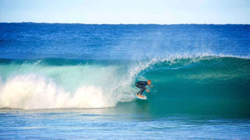 A surfer riding a large wave in the ocean.